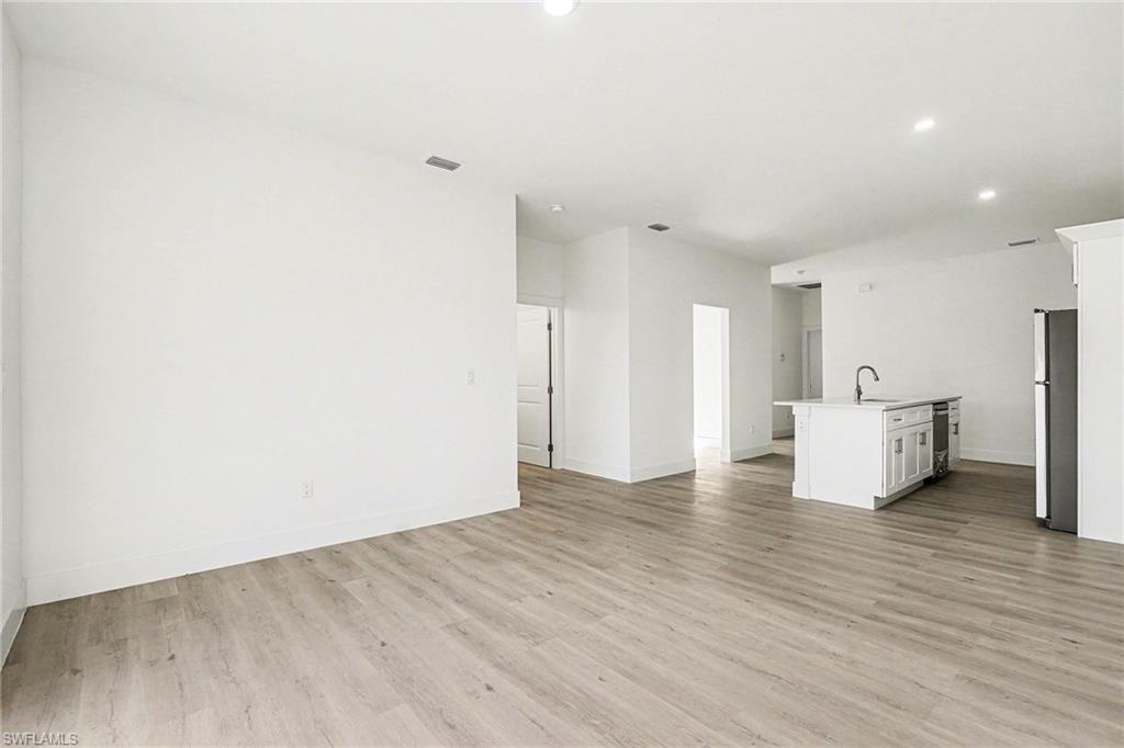 Unfurnished living room with light wood-type flooring and recessed lighting