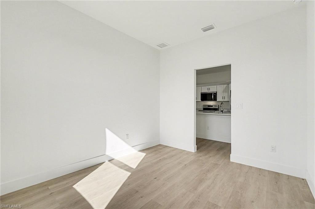 Unfurnished room with light wood-style floors and baseboards