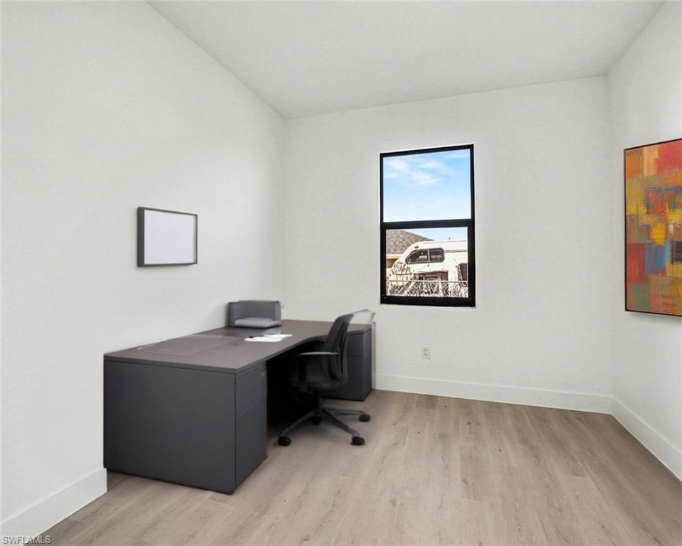 Office featuring light wood-style flooring and baseboards
