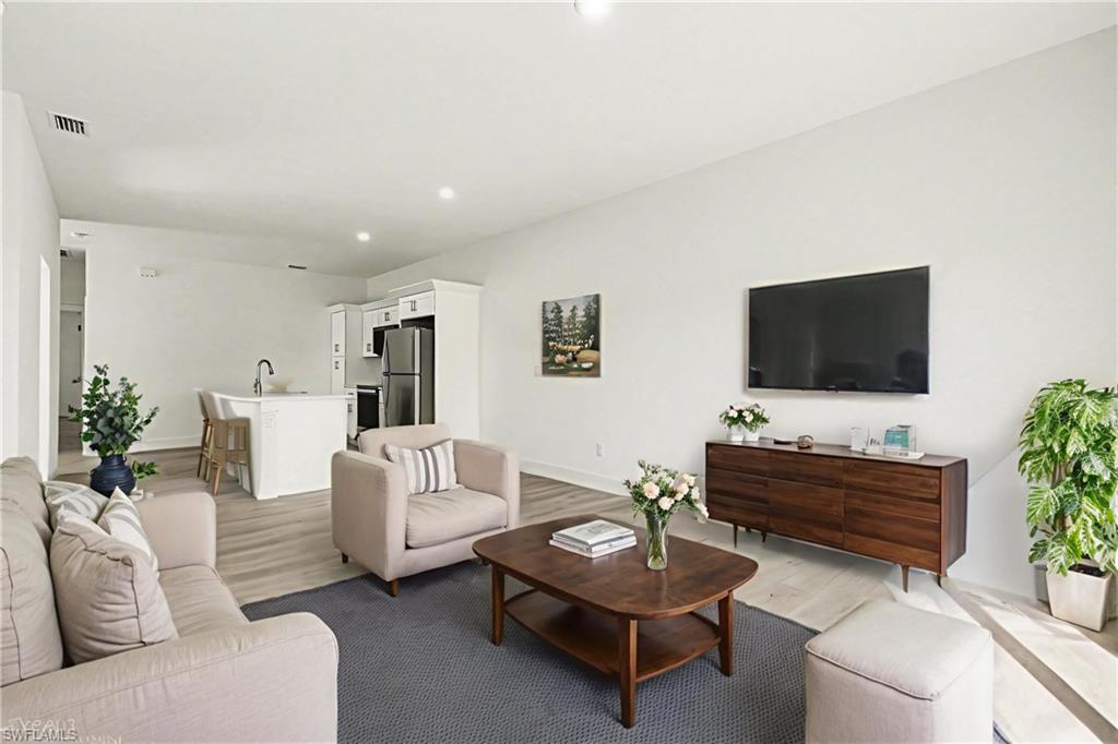 Living area with wood finished floors and recessed lighting