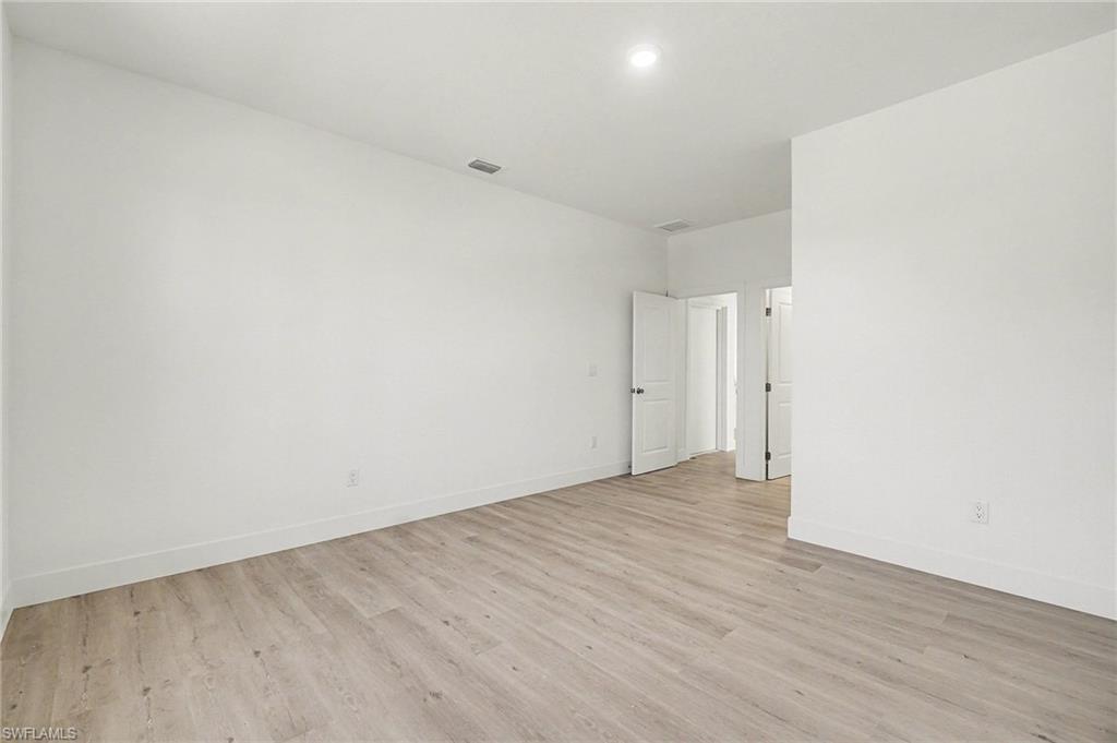 Empty room featuring light wood-style flooring and baseboards