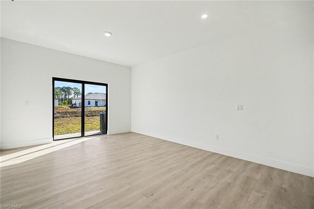 Spare room featuring light wood finished floors and recessed lighting