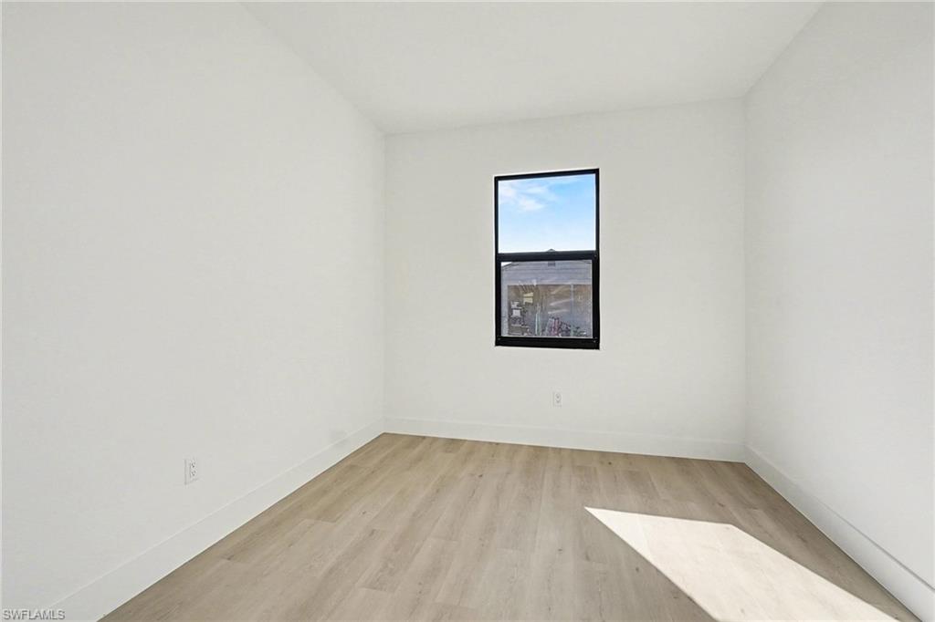Spare room with light wood-style floors and baseboards
