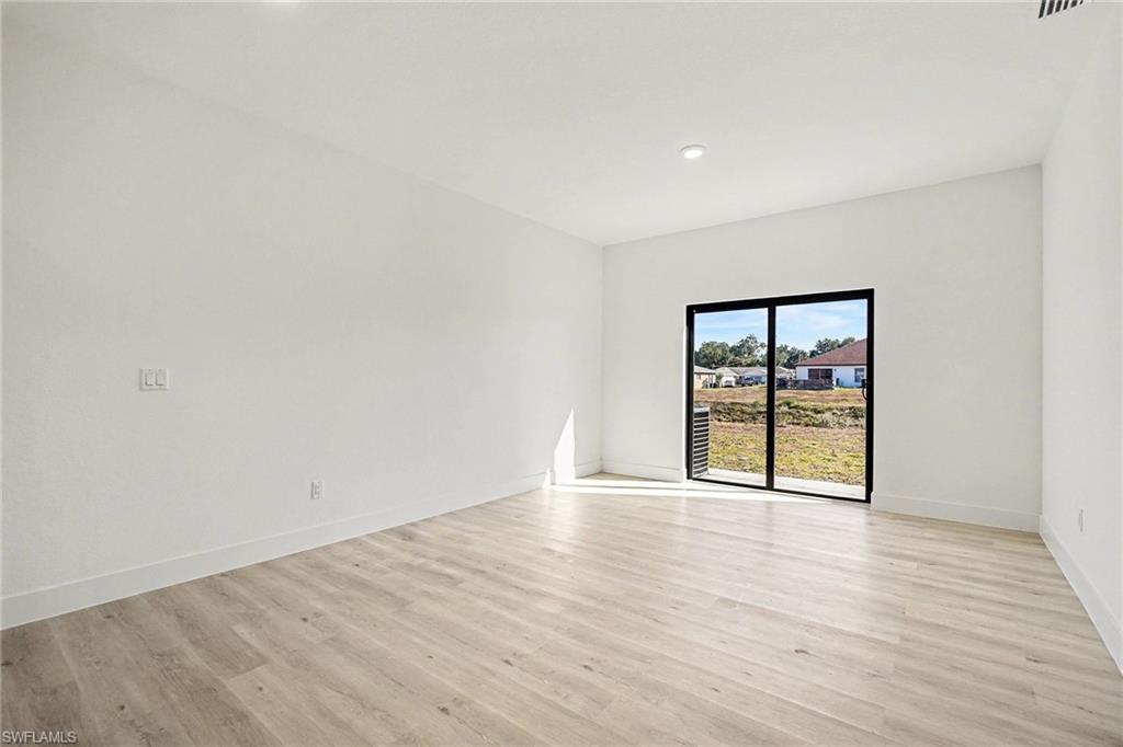 Spare room with light wood finished floors and recessed lighting