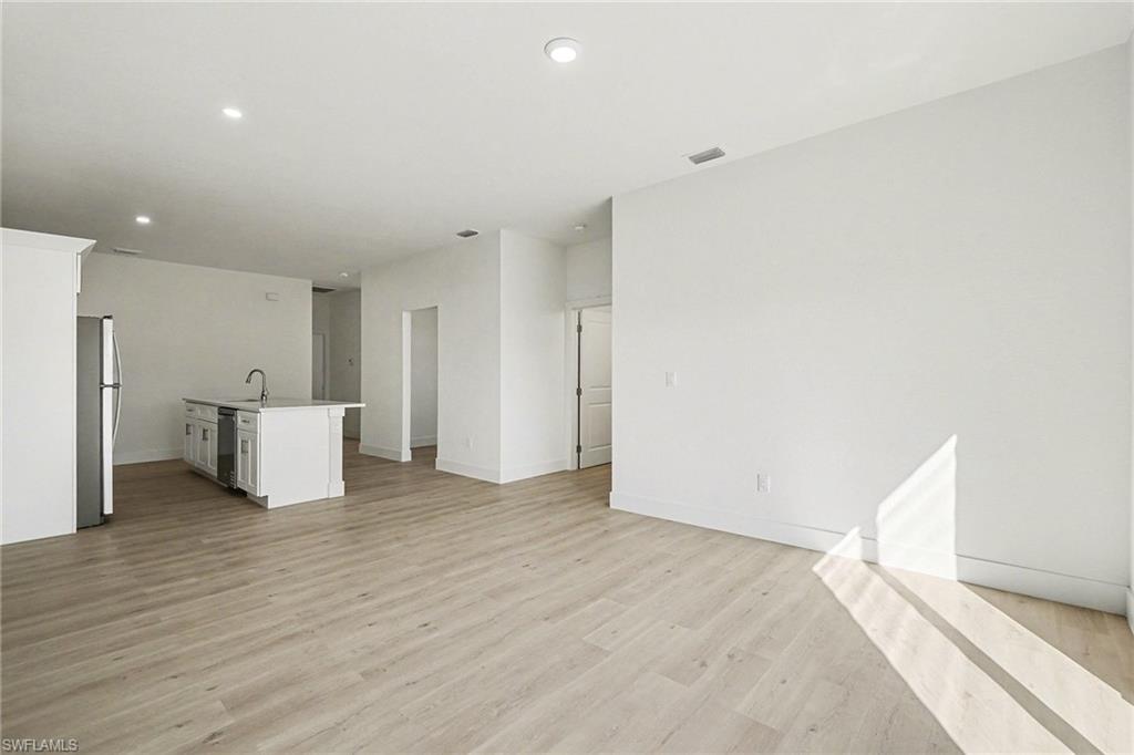 Unfurnished living room with light wood-style flooring and recessed lighting