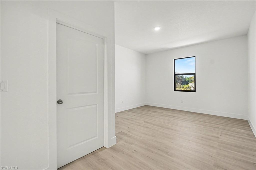 Unfurnished room featuring light wood-style flooring and baseboards