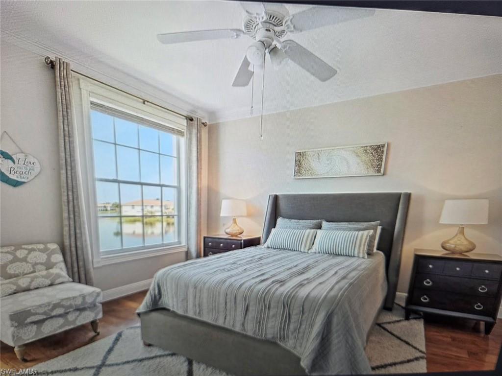Bedroom with wood finished floors, a water view, and ceiling fan