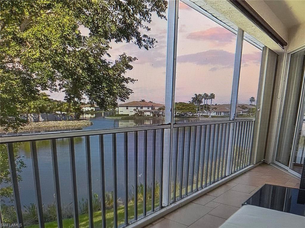 Balcony with a sunroom and a water view
