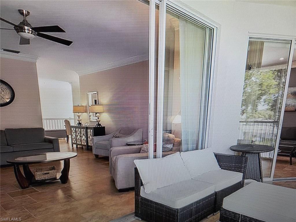 Living room featuring a ceiling fan and plenty of natural light