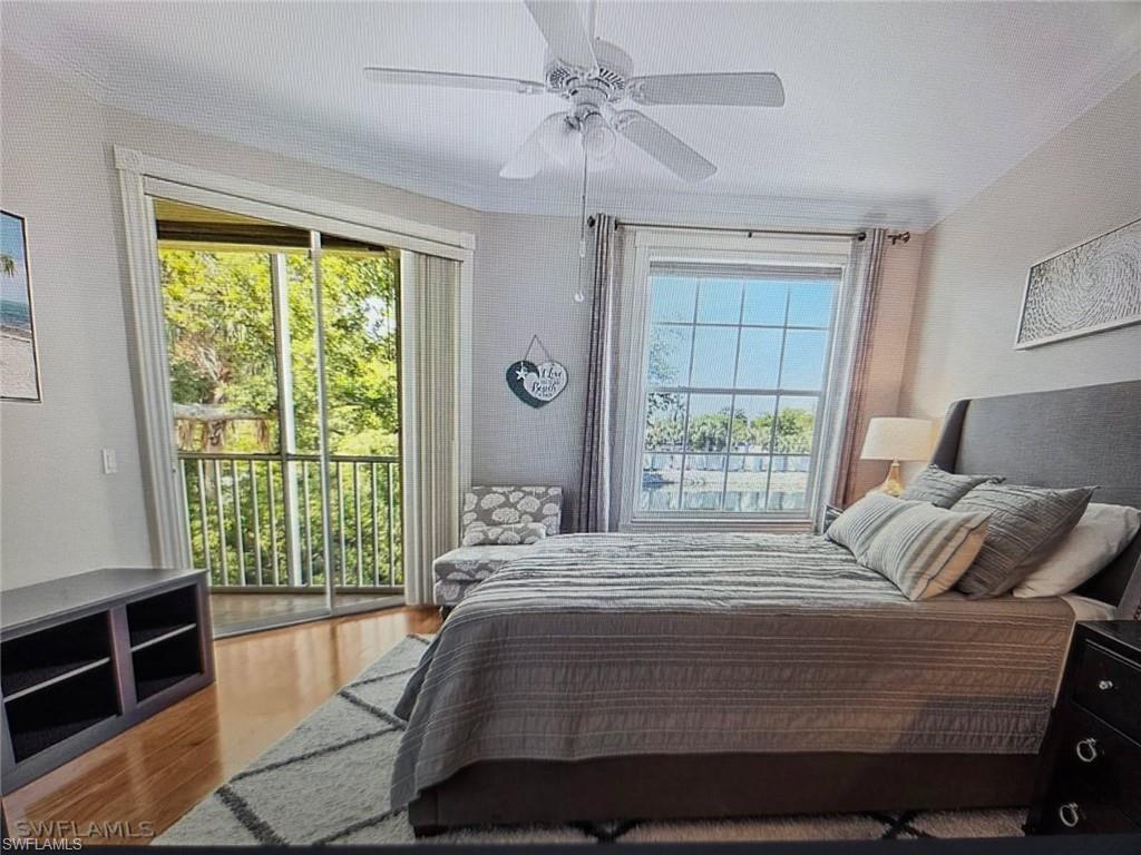 Bedroom with light wood finished floors, access to outside, and a ceiling fan