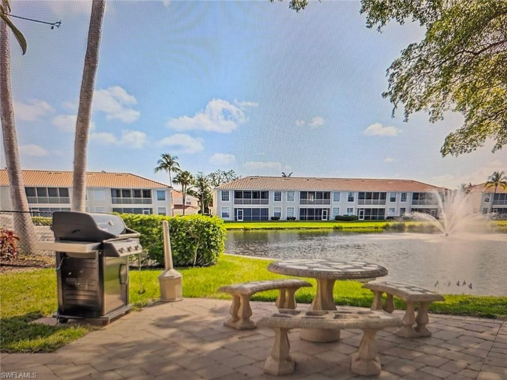 View of home's community with a water view and a patio