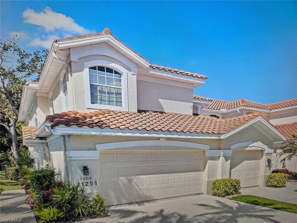 Mediterranean / spanish home featuring a tiled roof, driveway, and stucco siding