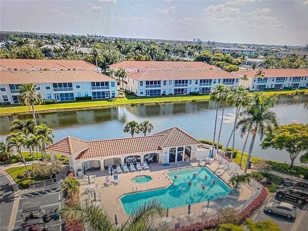 Community pool featuring a patio area and a water view