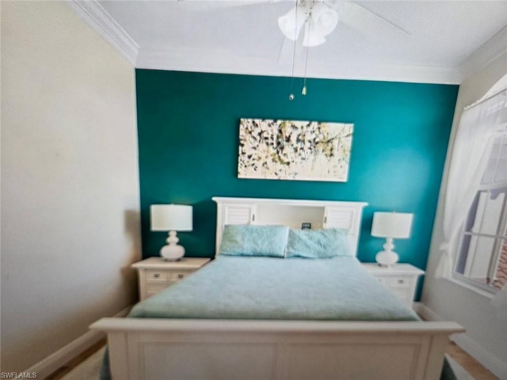 Bedroom with crown molding and ceiling fan