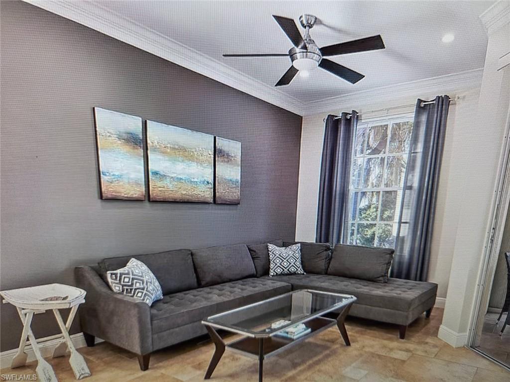 Living area featuring crown molding and a ceiling fan