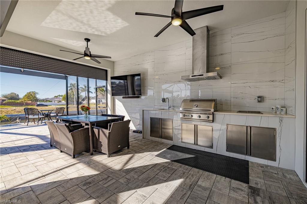 View of patio / terrace with an outdoor kitchen / dining area and ceiling fan
