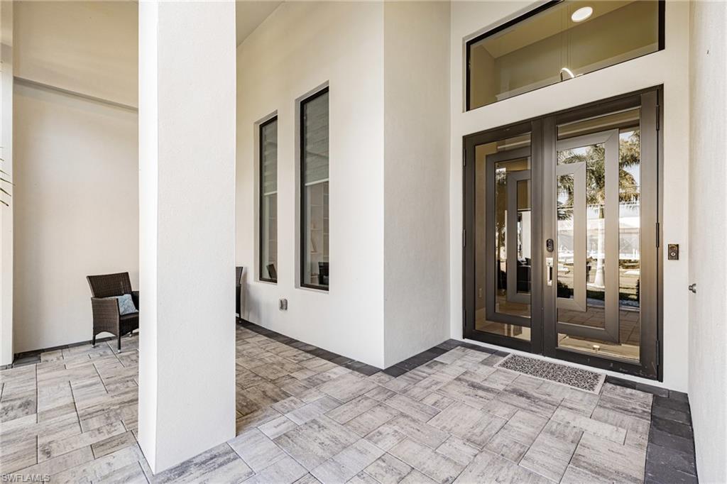 View of exterior entry with french doors and stucco siding