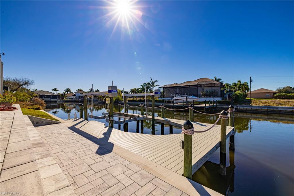 Dock featuring boat lift and a water view