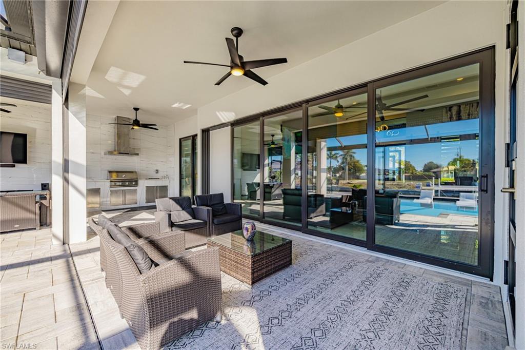 View of patio / terrace with a ceiling fan and an outdoor kitchen and area to lounge