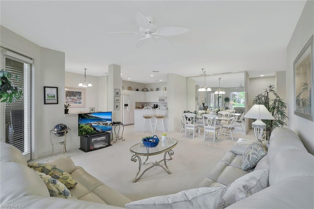 Living room with suspended lighting and ceiling fan