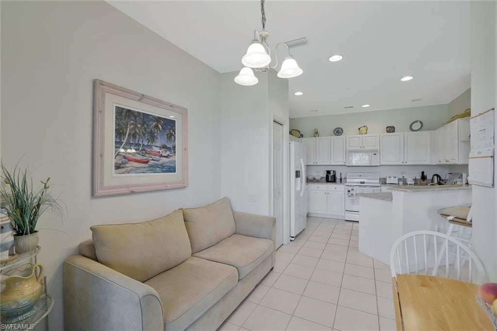 Living area with hanging lights and light tile patterned flooring