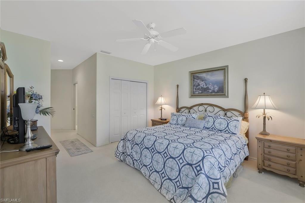 Bedroom with light carpet, a closet, ceiling fan, and recessed lighting