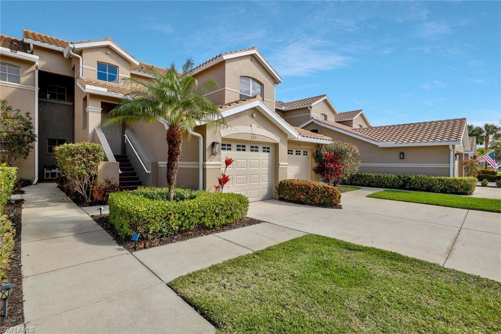 Mediterranean / spanish-style house with stucco siding, a garage, concrete driveway, a tiled roof, and a front yard