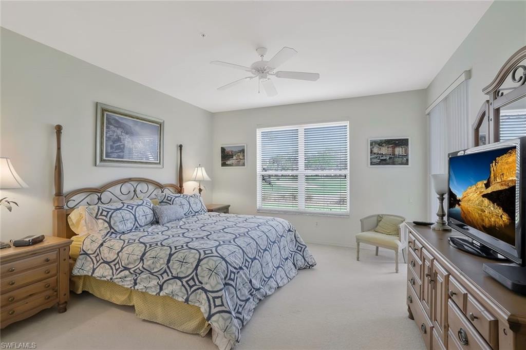 Bedroom featuring light colored carpet and ceiling fan
