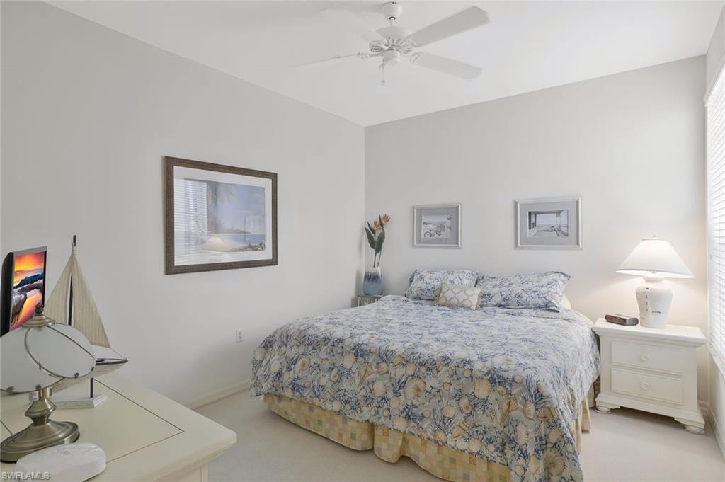 Bedroom with light colored carpet and ceiling fan