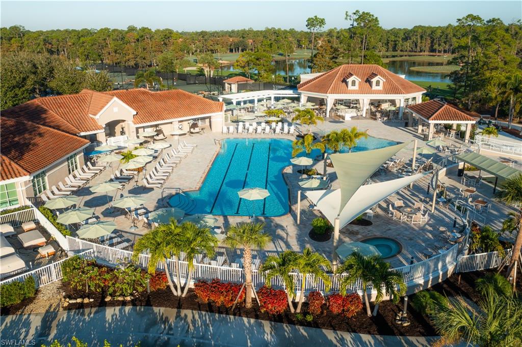 Community pool featuring a patio area and view of scattered trees