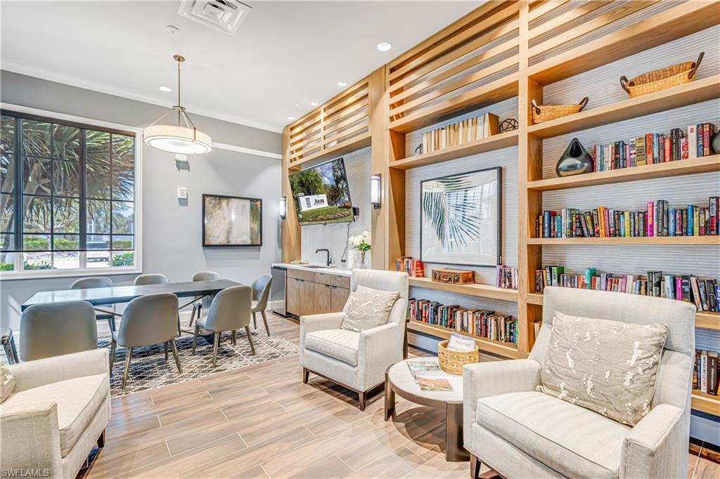 Sitting room with ornamental molding and recessed lighting