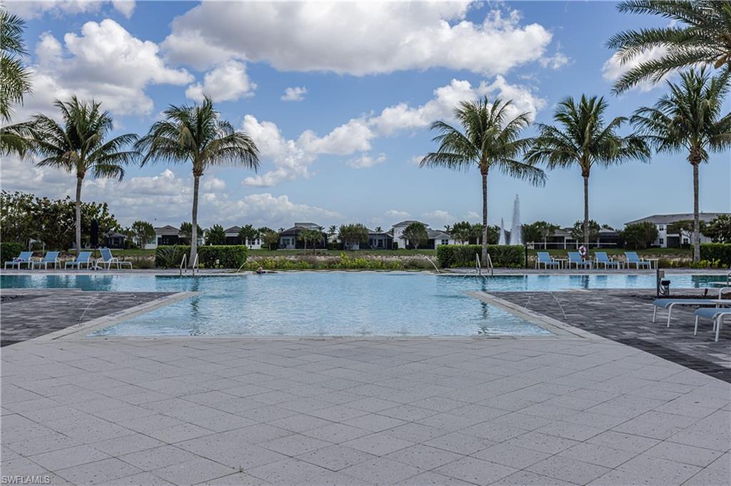 Community pool featuring a residential view and a patio area