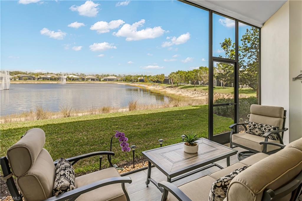 Sunroom with a water view, an outdoor lounge area, and a residential view