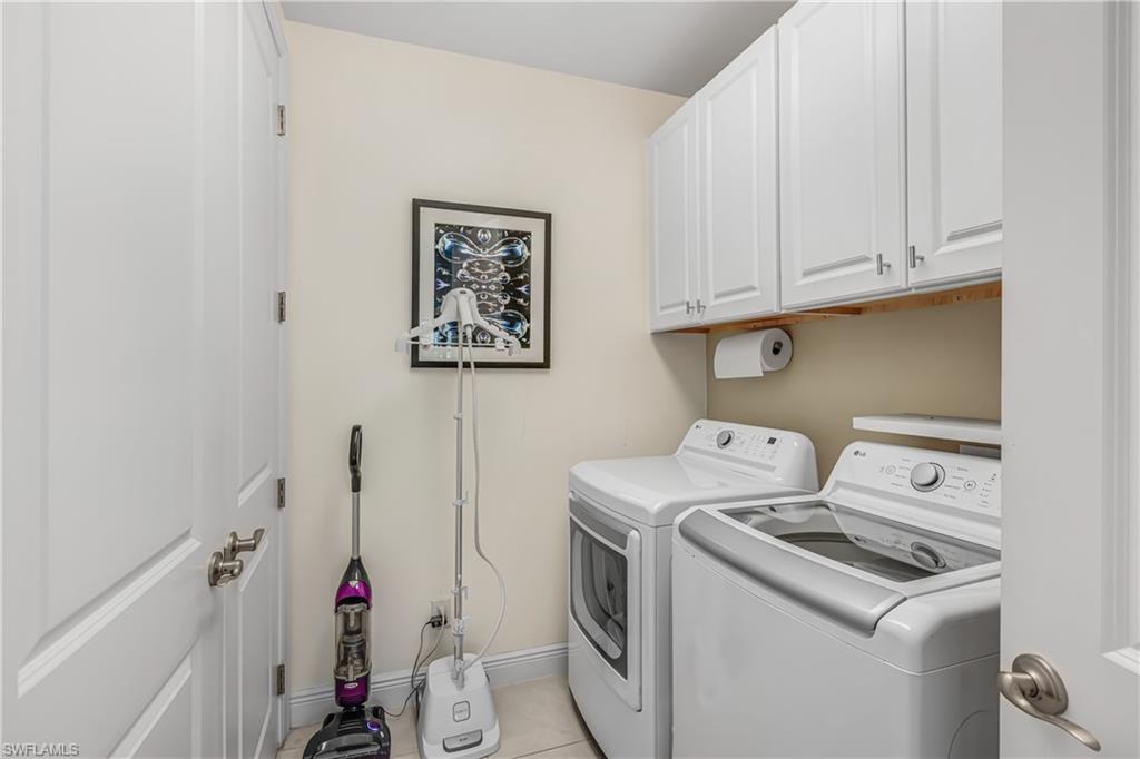 Laundry area featuring cabinet space and washing machine and dryer