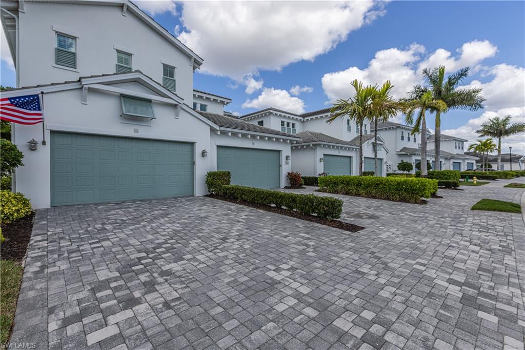 Mediterranean / spanish home featuring stucco siding, decorative driveway, and a garage
