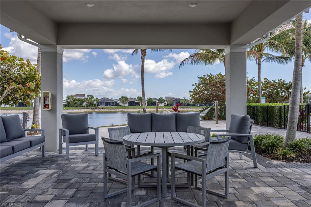 View of patio / terrace with a residential view, outdoor lounge area, and a water view