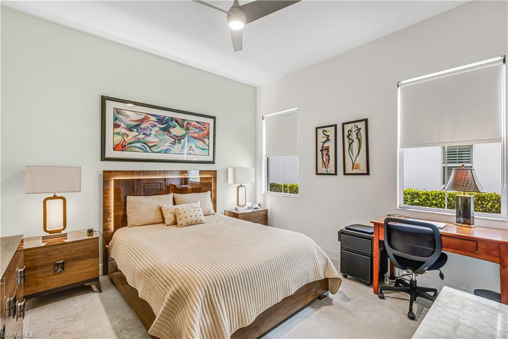 Bedroom with an office area and a ceiling fan