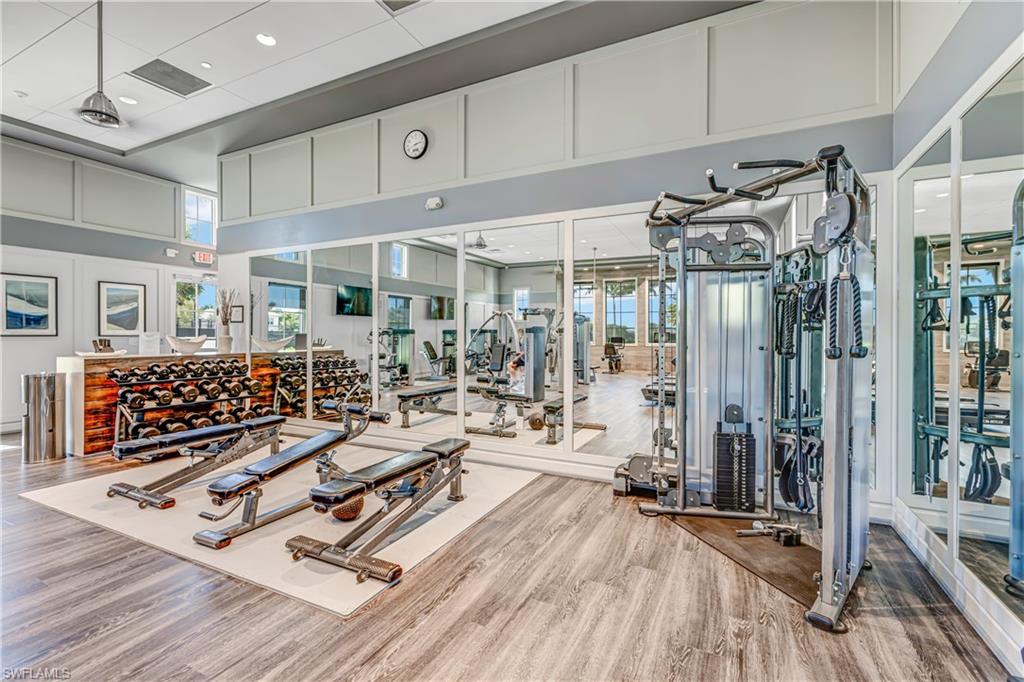 Exercise room featuring a high ceiling and recessed lighting