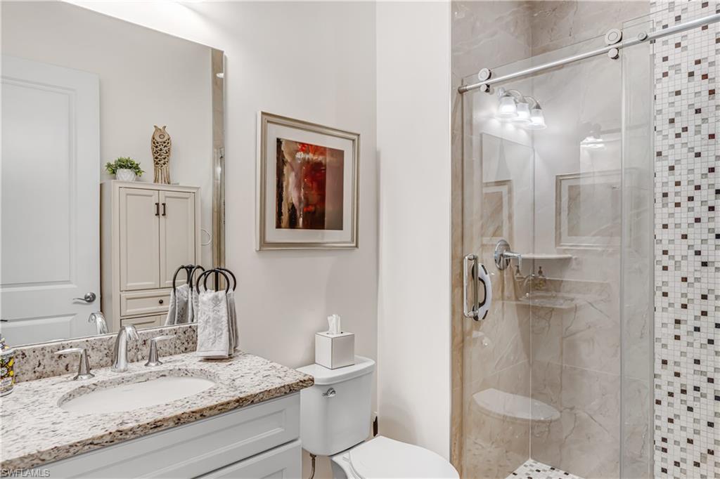 Full bathroom with vanity and a shower stall