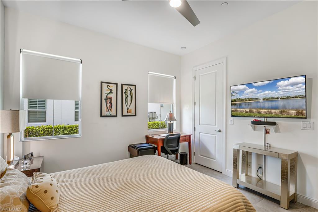 Bedroom featuring a ceiling fan and baseboards
