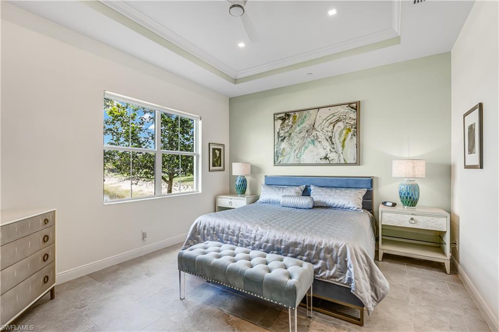 Bedroom with ornamental molding, a tray ceiling, a ceiling fan, and recessed lighting