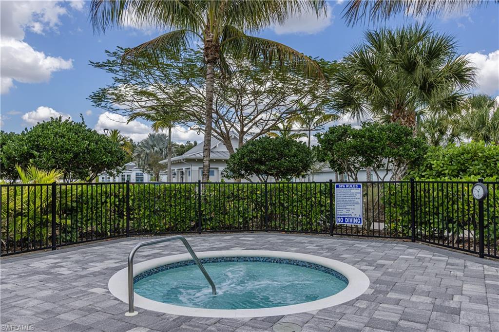 View of swimming pool featuring a hot tub