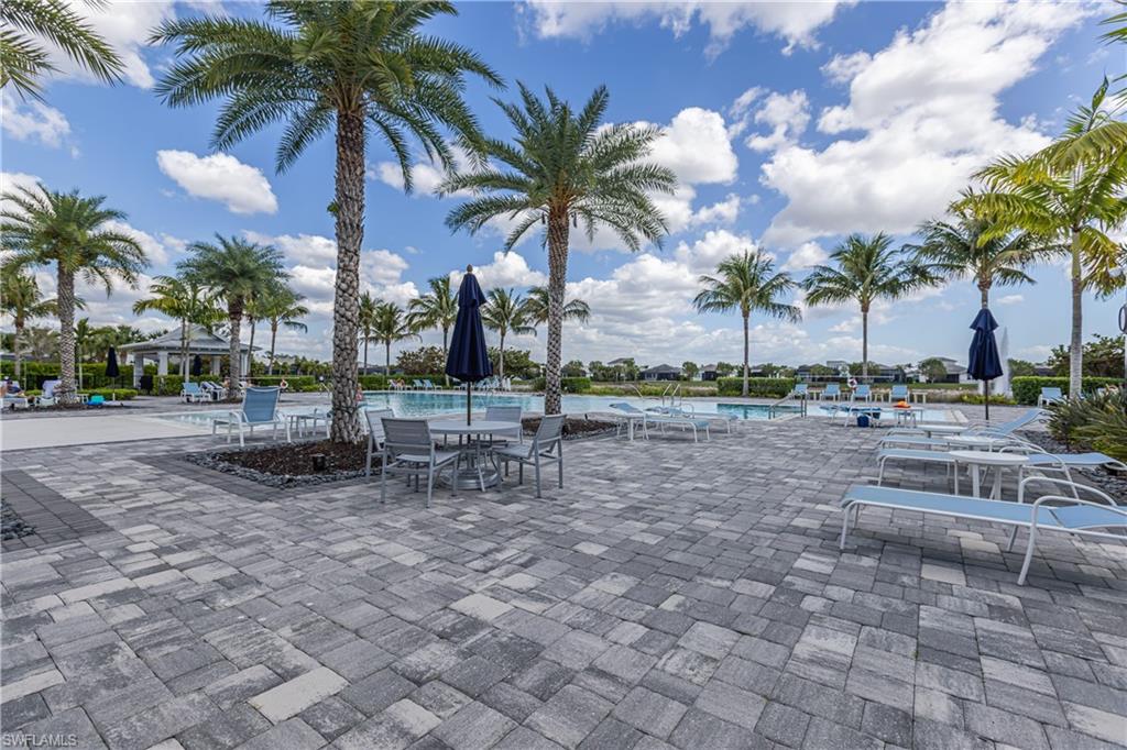View of patio / terrace with a community pool and outdoor dining area