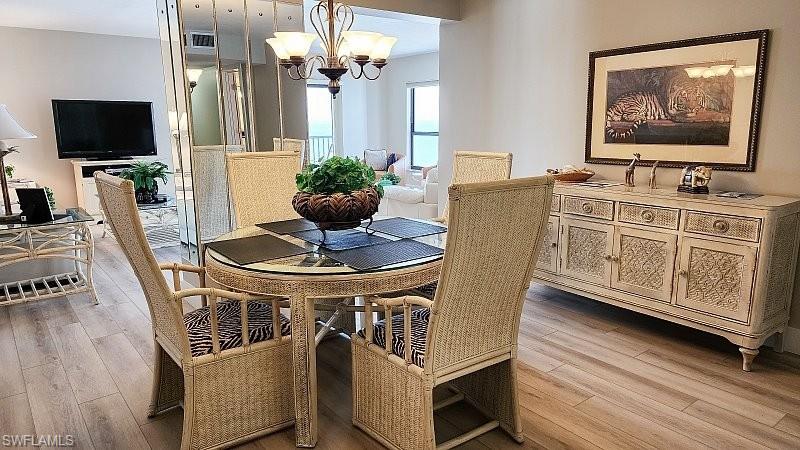 Dining room with a chandelier and light wood finished floors