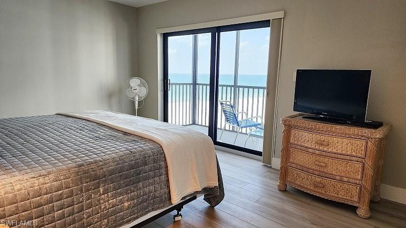 Bedroom featuring hardwood / wood-style flooring and access to exterior