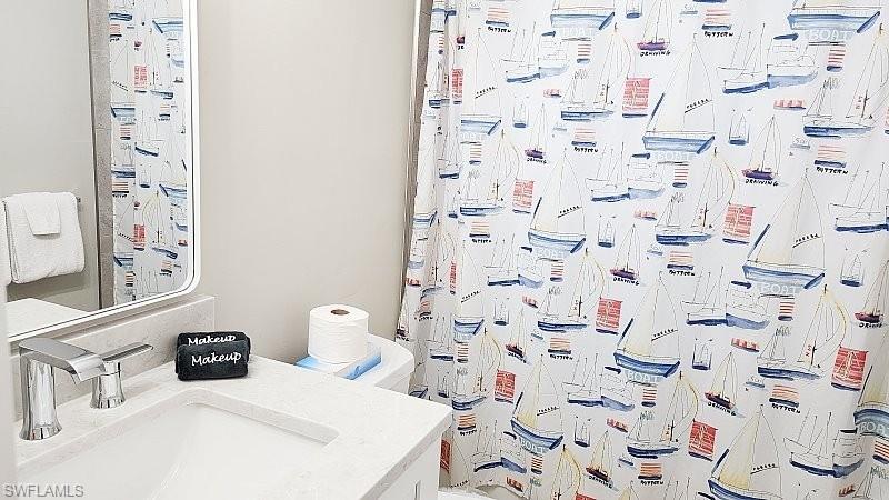 Full bath with vanity and a shower with curtain