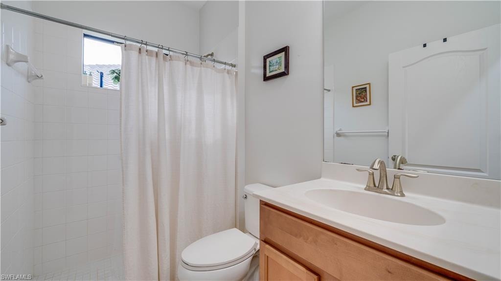Bathroom featuring vanity and a shower stall