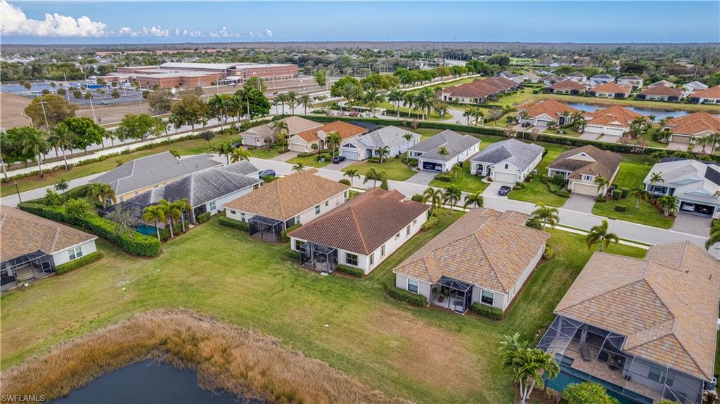 Aerial perspective of suburban area featuring a large body of water