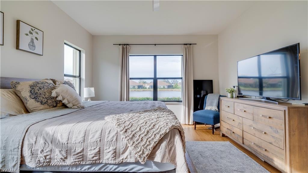 Bedroom with light wood-style floors and ceiling fan