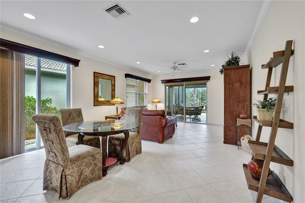 Dining area featuring light tile patterned flooring, crown molding, recessed lighting, and a ceiling fan